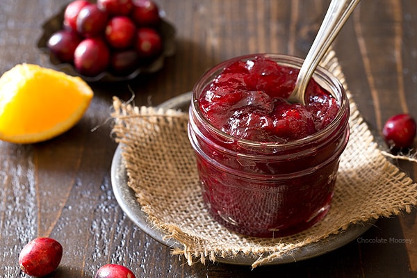 Homemade cranberry sauce with a spoon in a jar