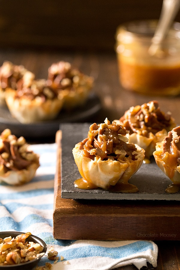 Looking for a bite-sized dessert to share with family and friends? These easy-to-serve No Bake Turtle Cheesecake Phyllo Cups with chocolate, caramel, and pecans will be a popular hit!