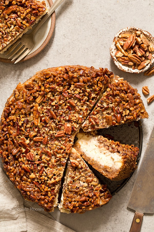 Pecan Pie Cheesecake cut into slices with one slice on its side