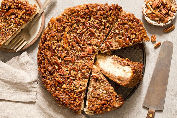 Pecan Pie Cheesecake cut into slices with one slice on its side