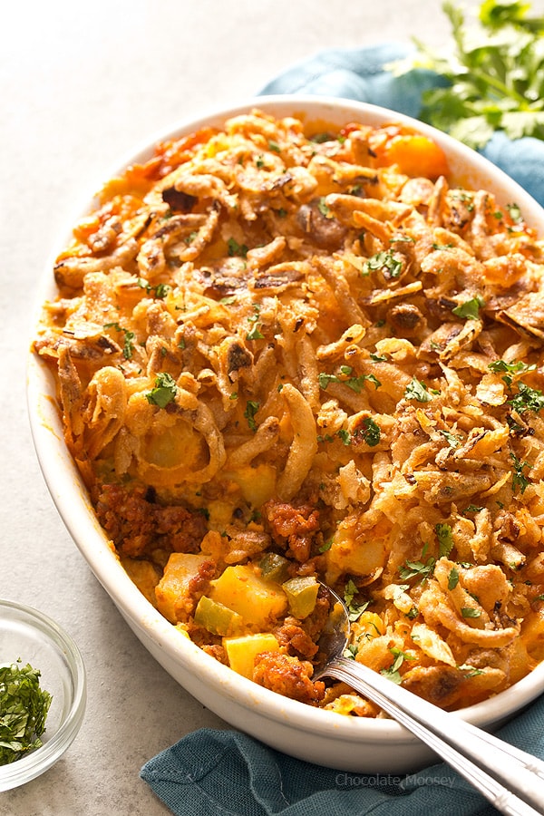 Cheesy chorizo potatoes in white casserole dish