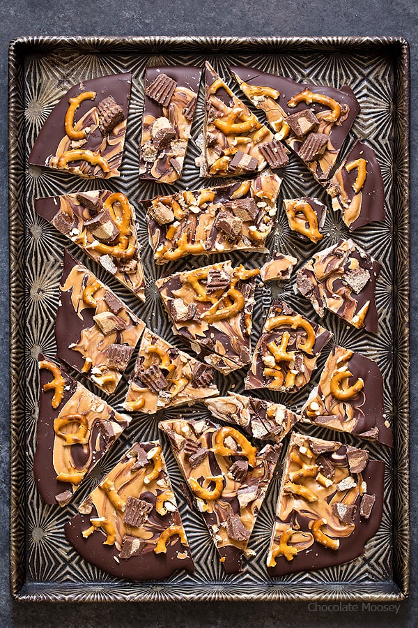 Broken up chocolate peanut butter bark on a cookie tray