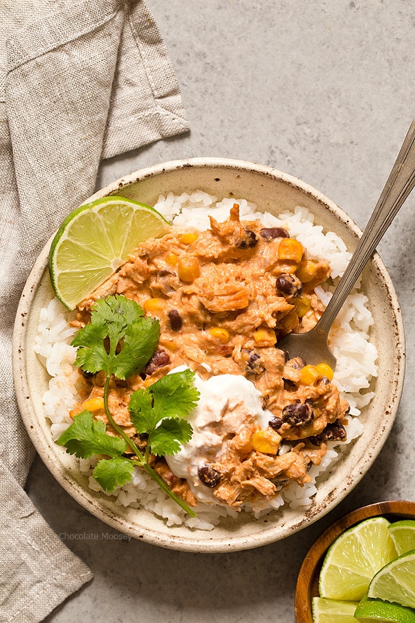 Warm and spicy small scale Slow Cooker Salsa Chicken served over rice with cilantro and lime. Recipe is scaled down to make 4 servings, enough to realistically feed 2 people.