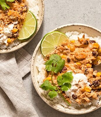 Warm and spicy small scale Slow Cooker Salsa Chicken served over rice with cilantro and lime. Recipe is scaled down to make 4 servings, enough to realistically feed 2 people.