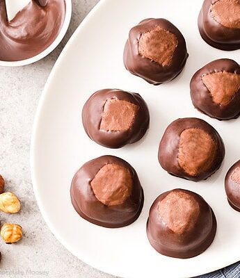 Break away from tradition and serve these Chocolate Hazelnut Buckeyes at your next party! The filling is made with chocolate hazelnut spread, giving this sweet treat a double dose of chocolate.