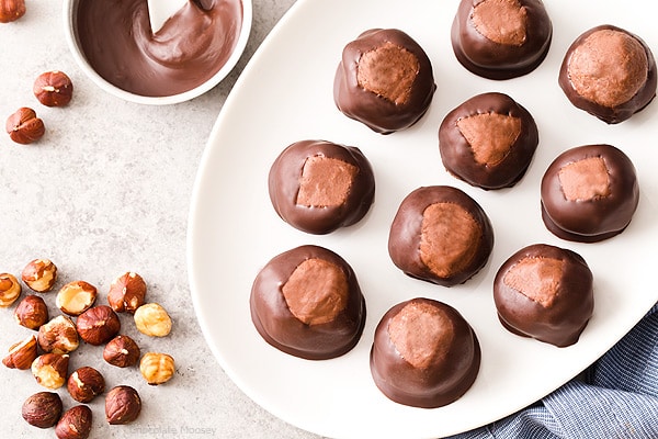 Break away from tradition and serve these Chocolate Hazelnut Buckeyes at your next party! The filling is made with chocolate hazelnut spread, giving this sweet treat a double dose of chocolate.