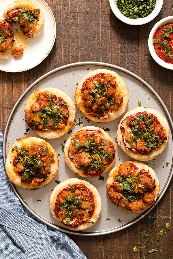 Serving pizza is popular for a party, but sometimes you don't have room for a whole slice. Problem solved with these Italian Sausage Pizza Bites, which are mini pizzas topped with a homemade pizza sauce, mozzarella cheese, and hot Italian sausage with peppers.