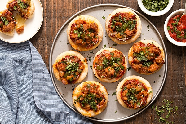 Serving pizza is popular for a party, but sometimes you don't have room for a whole slice. Problem solved with these Italian Sausage Pizza Bites, which are mini pizzas topped with a homemade pizza sauce, mozzarella cheese, and hot Italian sausage with peppers. 