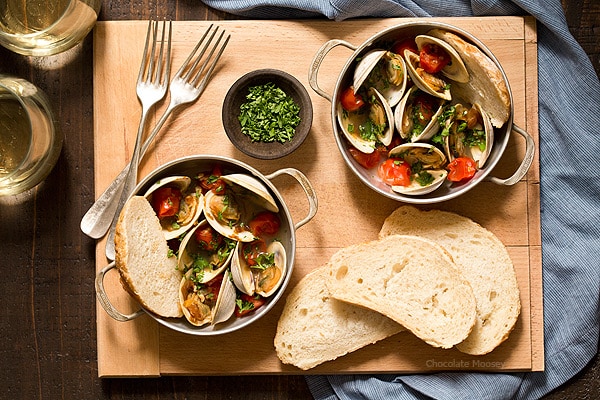 Learn how to make Steamed Clams with Pan Roasted Tomatoes as an easy date night appetizer to make at home! This recipe makes enough to serve two people, ideal for Valentine’s Day, anniversaries, birthdays, and days off together.