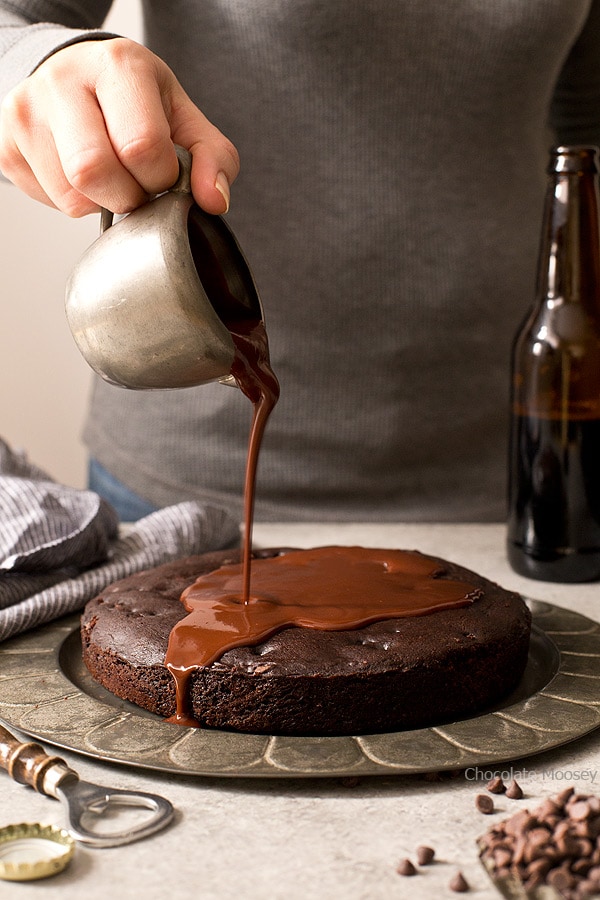 Pouring ganache over chocolate cake