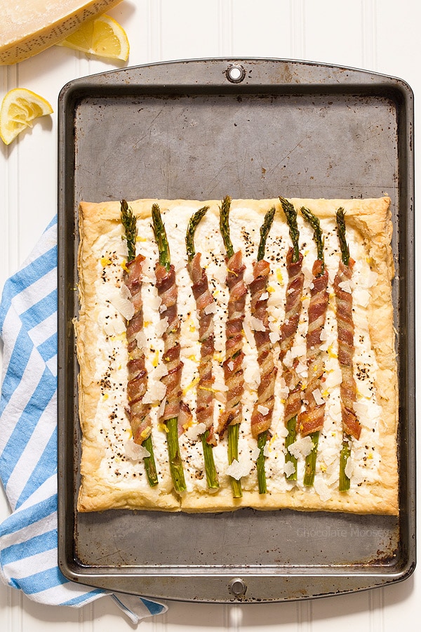 Bacon Wrapped Asparagus Puff Pastry Tart with a Parmesan ricotta cheese filling is a delicate, flakey appetizer to celebrate spring and Easter. Serve it for brunch or dinner. 