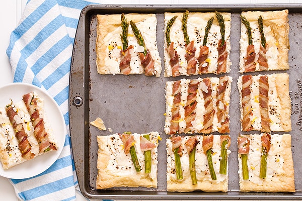 Bacon Wrapped Asparagus Puff Pastry Tart with a Parmesan ricotta cheese filling is a delicate, flakey appetizer to celebrate spring and Easter. Serve it for brunch or dinner.