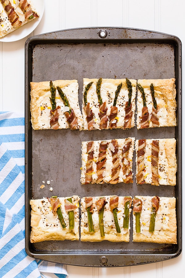 Bacon Wrapped Asparagus Puff Pastry Tart with a Parmesan ricotta cheese filling is a delicate, flakey appetizer to celebrate spring and Easter. Serve it for brunch or dinner.