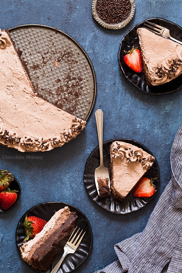 Plated slices of Brownie Bottom Chocolate Mousse Cake with chocolate whipped cream