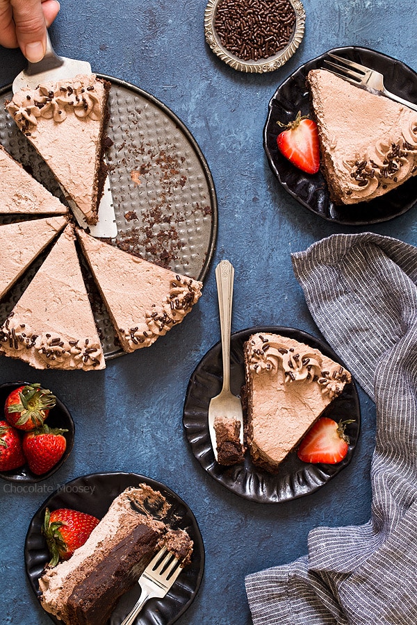 Serving slices of Brownie Bottom Chocolate Mousse Cake with chocolate whipped cream