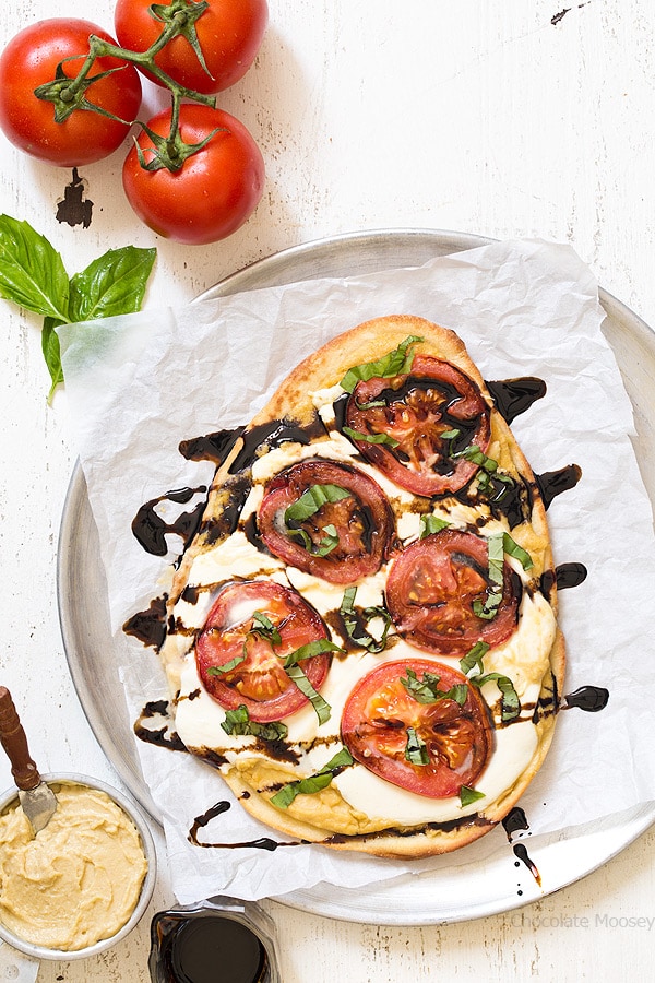 Caprese Hummus Flatbread Pizza with fresh tomatoes, sliced mozzarella cheese, basil, and balsamic vinegar