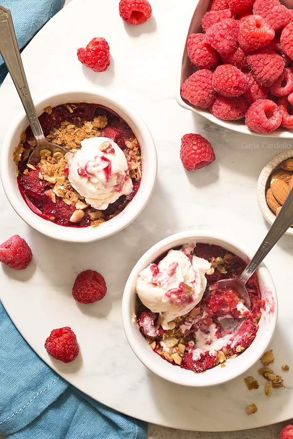 mini Raspberry Almond Crisp For Two with a sweet and slightly tart raspberry filling topped with a crispy almond streusel baked in two ramekins.