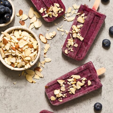 Cool down this summer with something colorful and refreshing! Blueberry Yogurt Pops with almonds and a secret ingredient that makes their flavor pop.