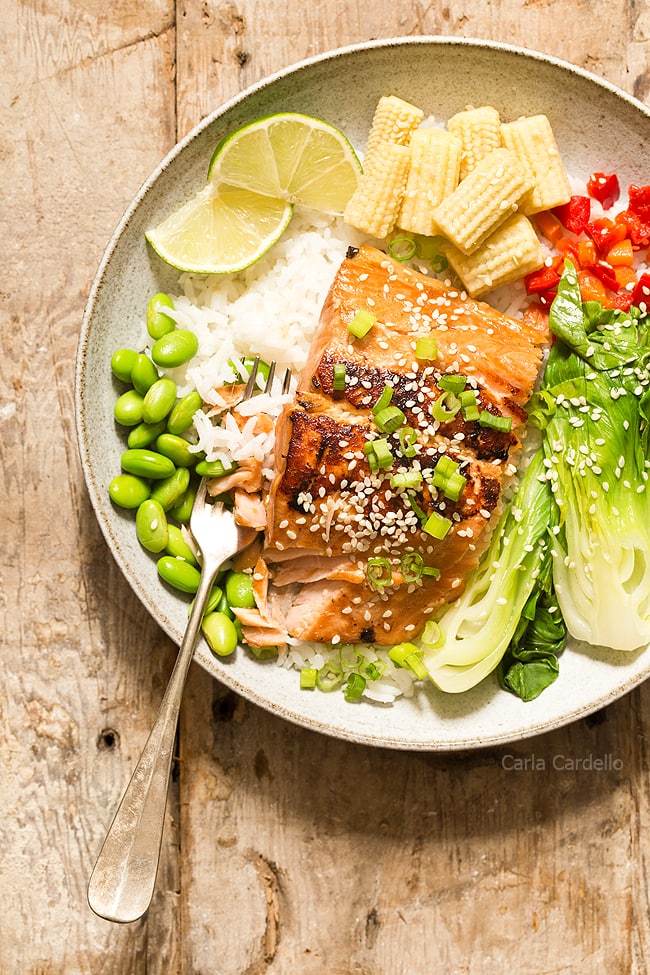 Ginger garlic salmon in bowl with fork