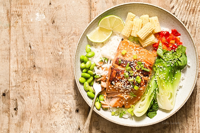 Ginger garlic salmon in bowl with fork