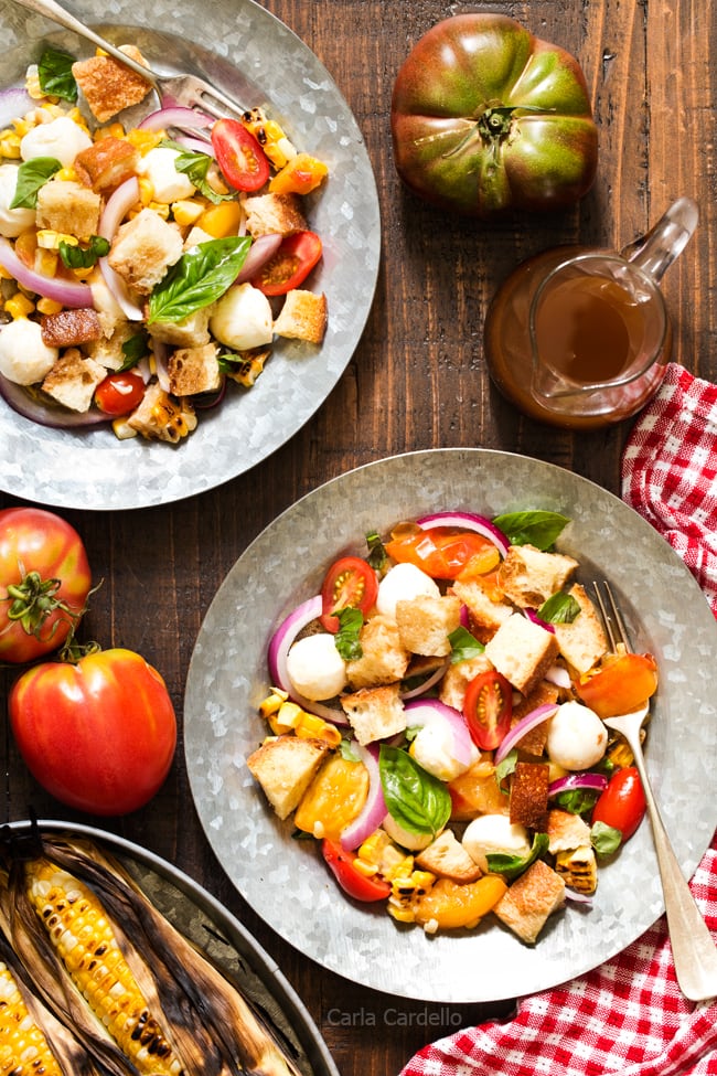 Say hello to summer on a plate! Grilled Corn Panzanella Salad with tomatoes, mozzarella cheese, basil, and homemade croutons.