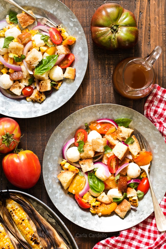 Say hello to summer on a plate! Grilled Corn Panzanella Salad with tomatoes, mozzarella cheese, basil, and homemade croutons. 