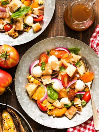 Say hello to summer on a plate! Grilled Corn Panzanella Salad with tomatoes, mozzarella cheese, basil, and homemade croutons.