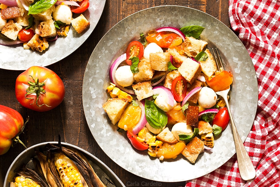 Say hello to summer on a plate! Grilled Corn Panzanella Salad with tomatoes, mozzarella cheese, basil, and homemade croutons.