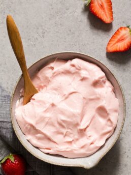 Bowl of pink strawberry cream cheese frosting