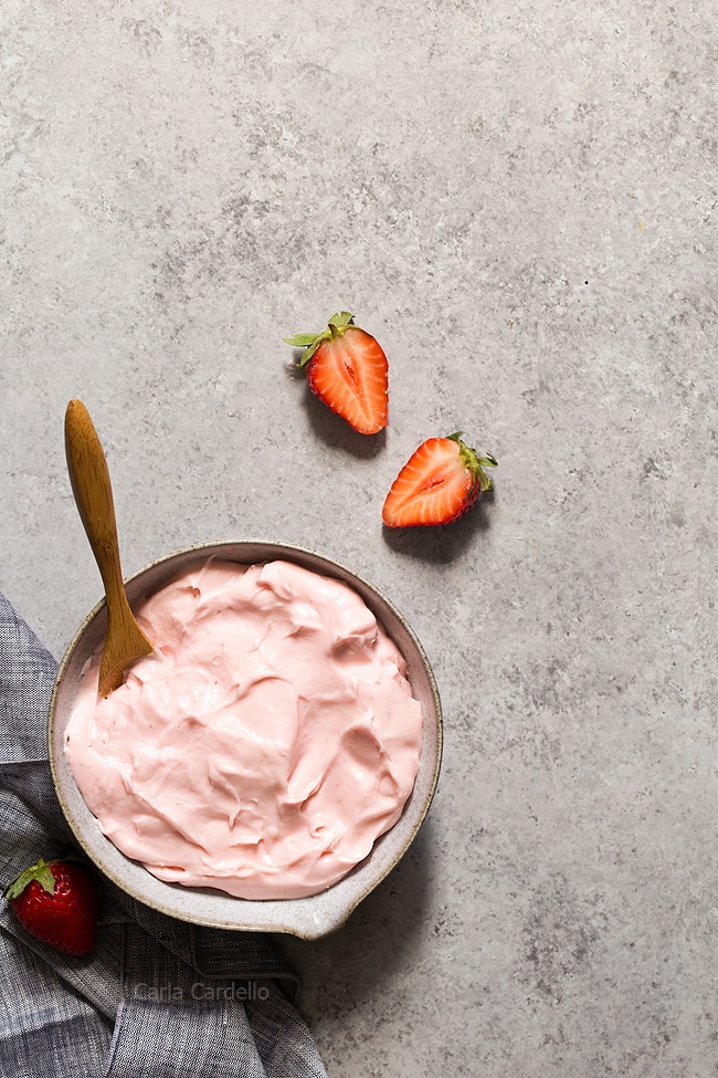 Bowl of pink strawberry frosting