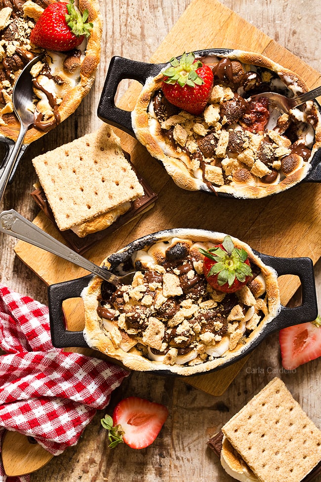 No campfire needed for Strawberry S'mores Cobbler with a chocolate strawberry filling topped with toasted marshmallows and graham cracker pieces. Bake them in the oven for a gooey, irresistible smores dessert!
