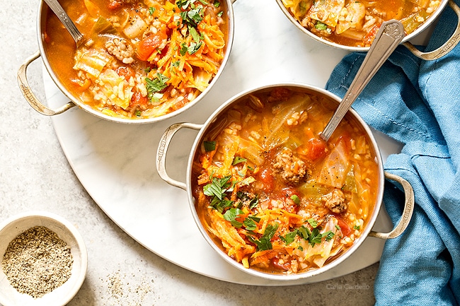 Love cabbage rolls but hate making them? Stuffed Cabbage Soup has the same ingredients as stuffed cabbage rolls - ground beef, rice, tomatoes, and cabbage - minus the extra time and effort to assemble them.