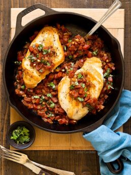 Chicken with tomatoes in cast iron skillet