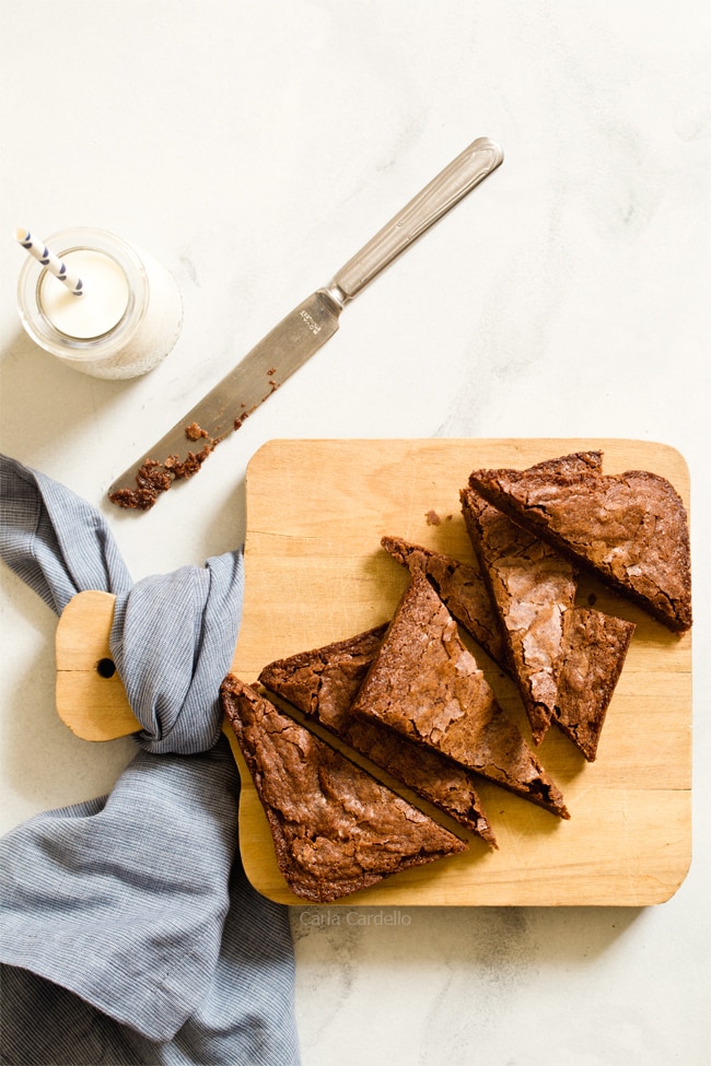 Small Batch Brownies cut into triangles on a cutting board