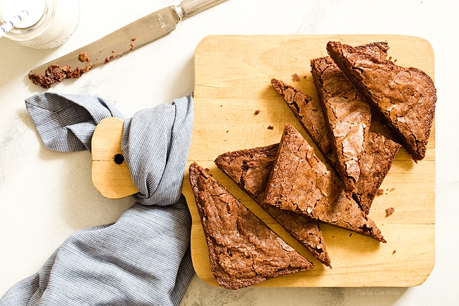 Small Batch Brownies cut into triangles on a cutting board