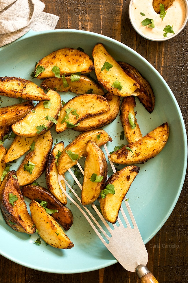 Close up of potato wedges on spatula