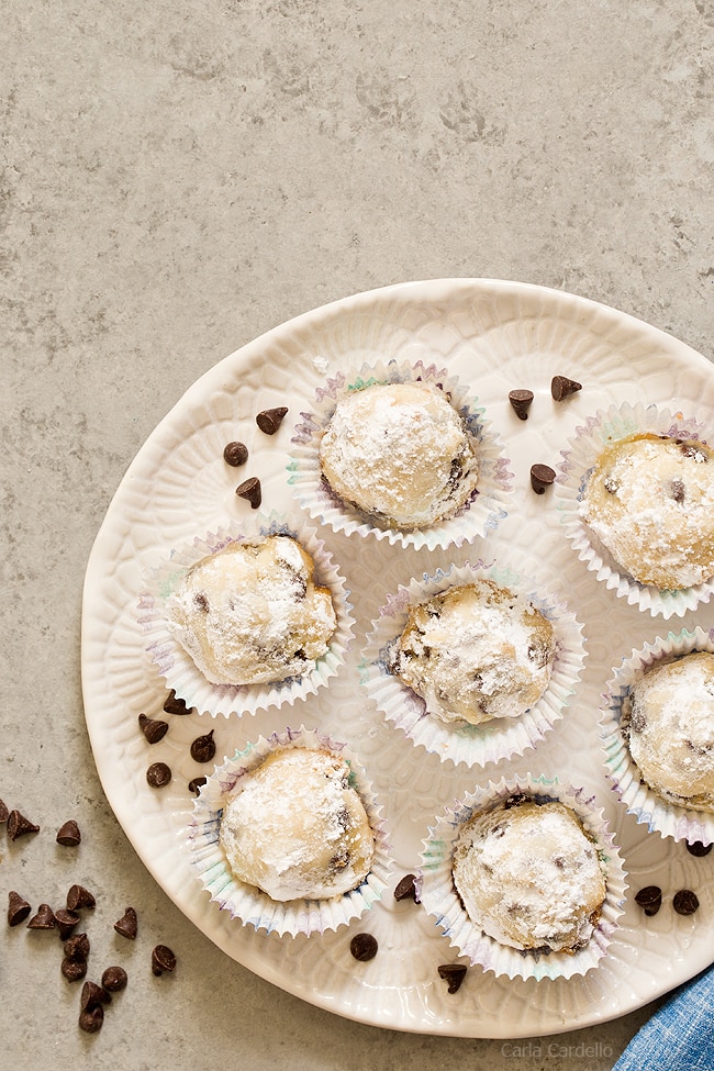 Close up of chocolate chip snowball cookies on a white plate