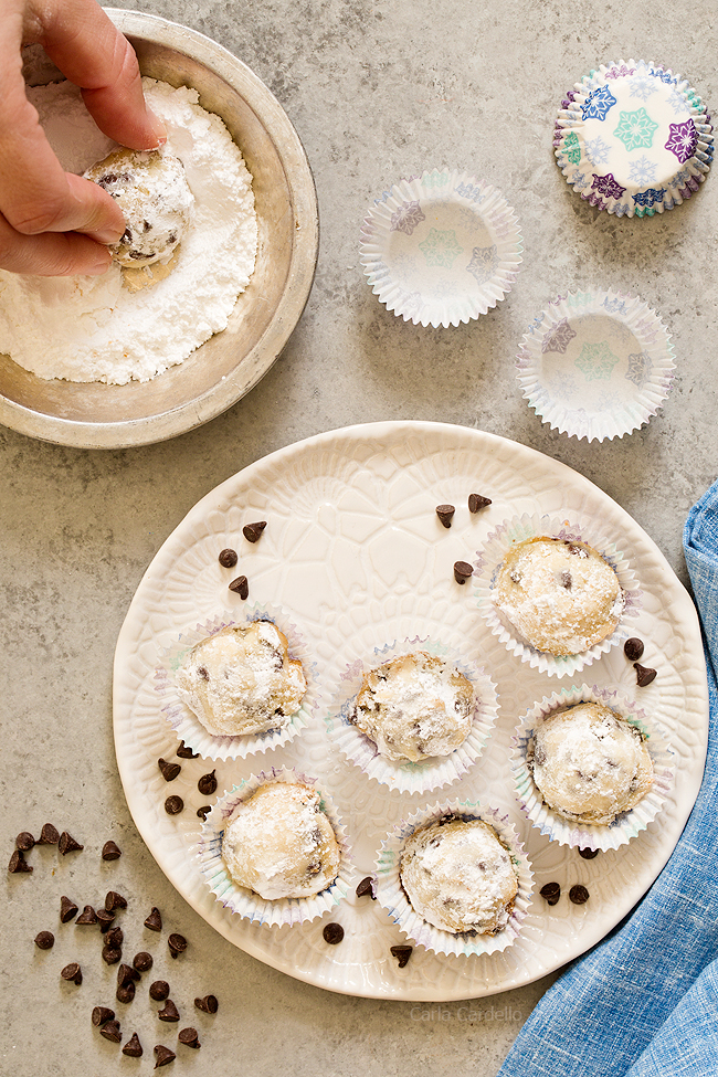 Rolling snowball cookies in powdered sugar