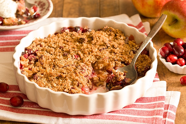 Stuck with extra cranberries and tired of cranberry sauce? Throw together this easy small batch Cranberry Apple Crisp with pecans. Warm and comforting in every bite!
