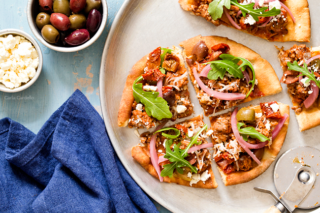 Put a Mediterranean twist on pizza night with Greek Pita Pizza! Top yours with ground lamb, olives, feta, pickled red onion, and arugula for an easy yet fulfilling meal.