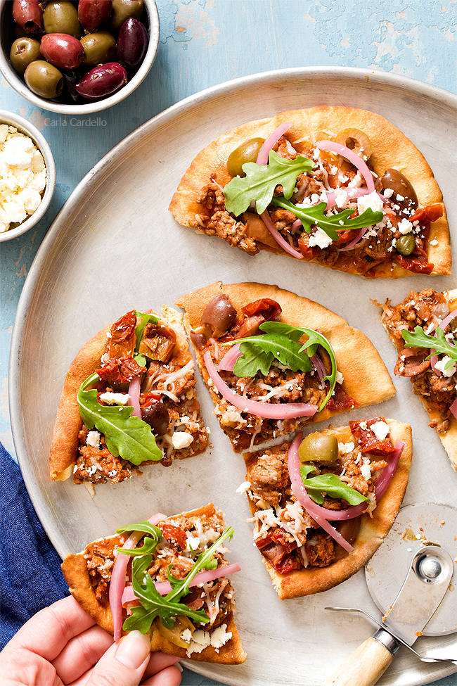 Put a Mediterranean twist on pizza night with Greek Pita Pizza! Top yours with ground lamb, olives, feta, pickled red onion, and arugula for an easy yet fulfilling meal.