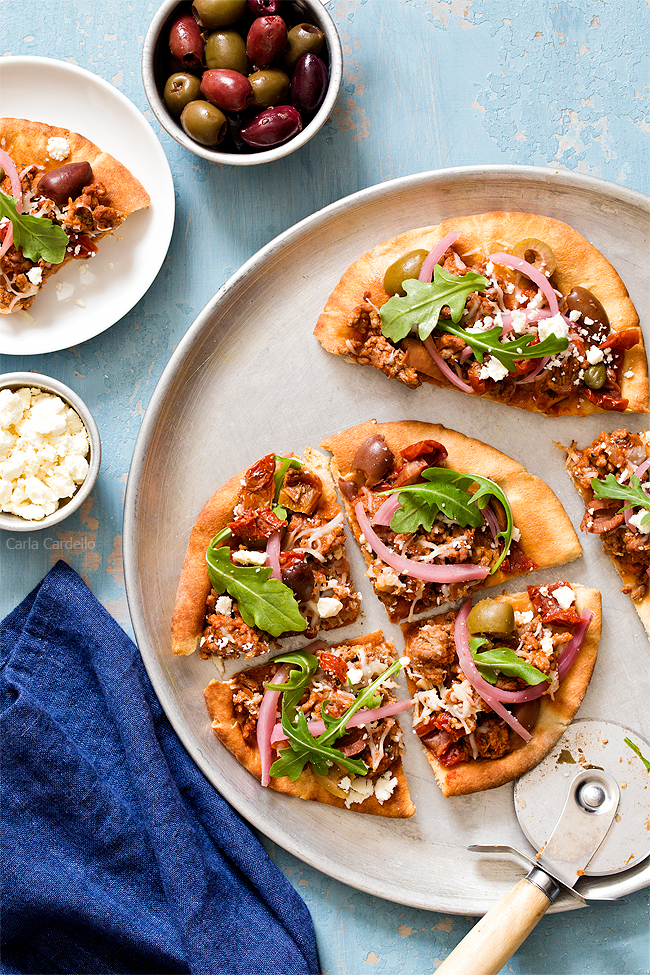 Put a Mediterranean twist on pizza night with Greek Pita Pizza! Top yours with ground lamb, olives, feta, pickled red onion, and arugula for an easy yet fulfilling meal. 