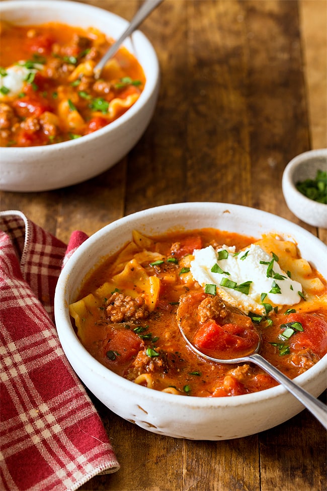 Lasagna soup in white bowl with spoon