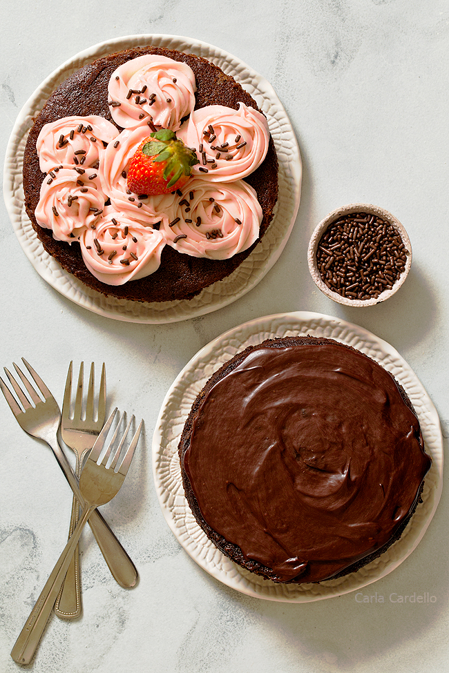 Two chocolate cakes on white plates