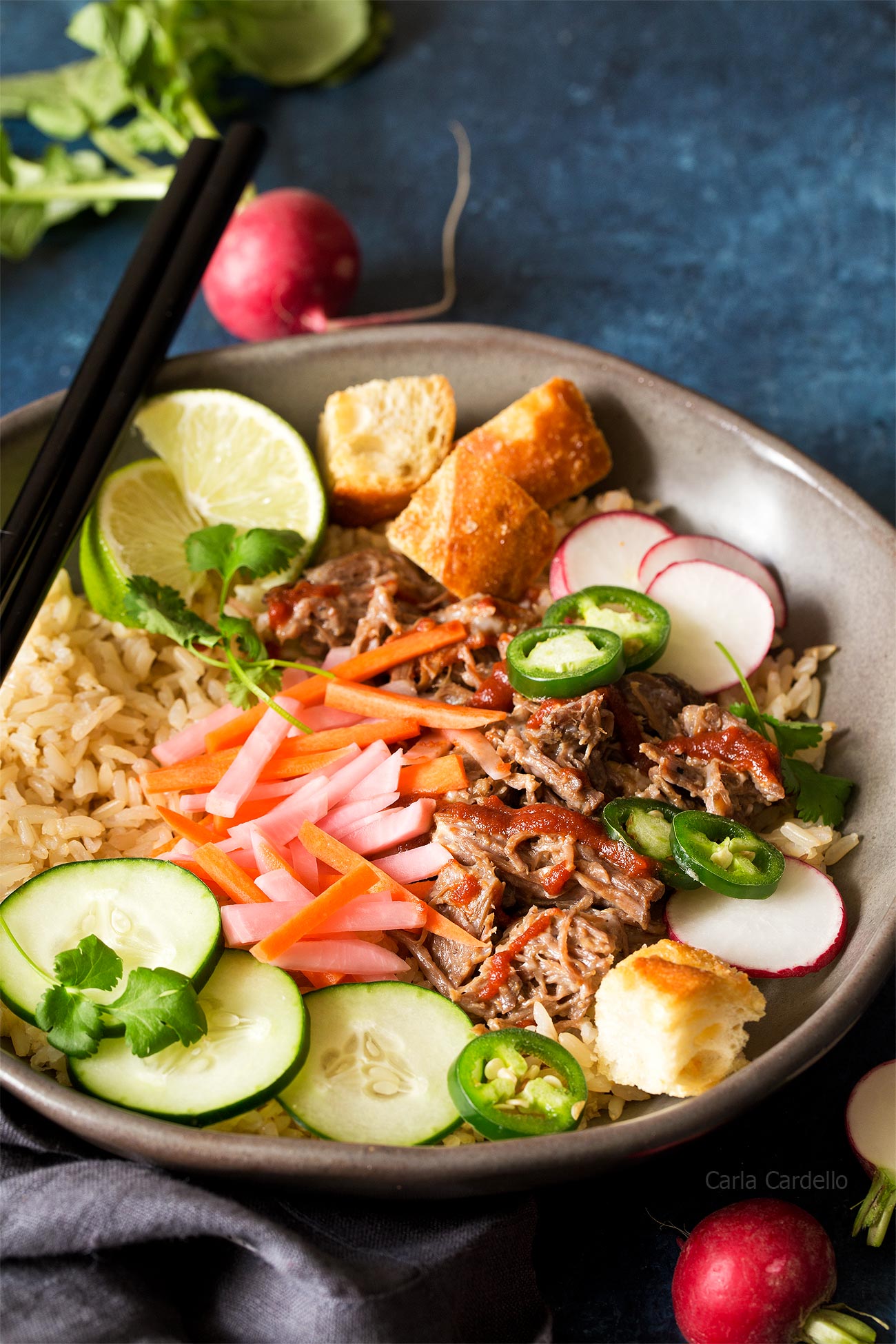 Slow Cooker Banh Mi Rice Bowls with shredded pork, pickled carrots, pickled radishes, and baguette croutons