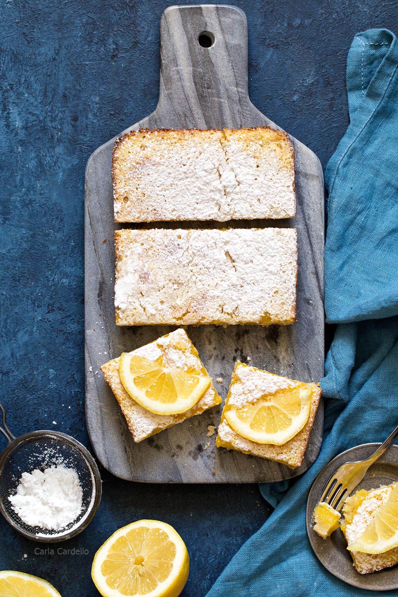 Lemon bars on a marble cutting board