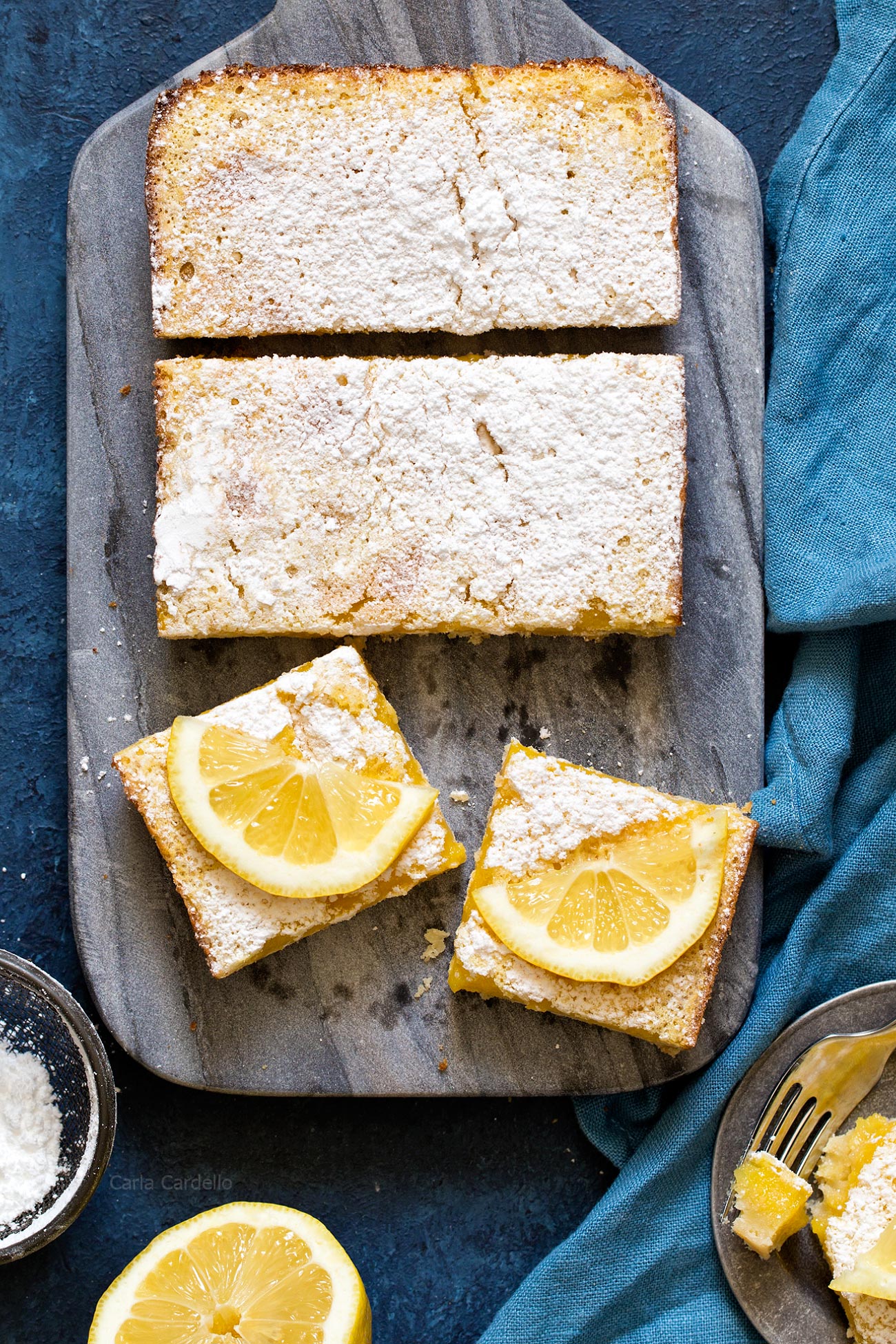 Lemon bars on a marble cutting board