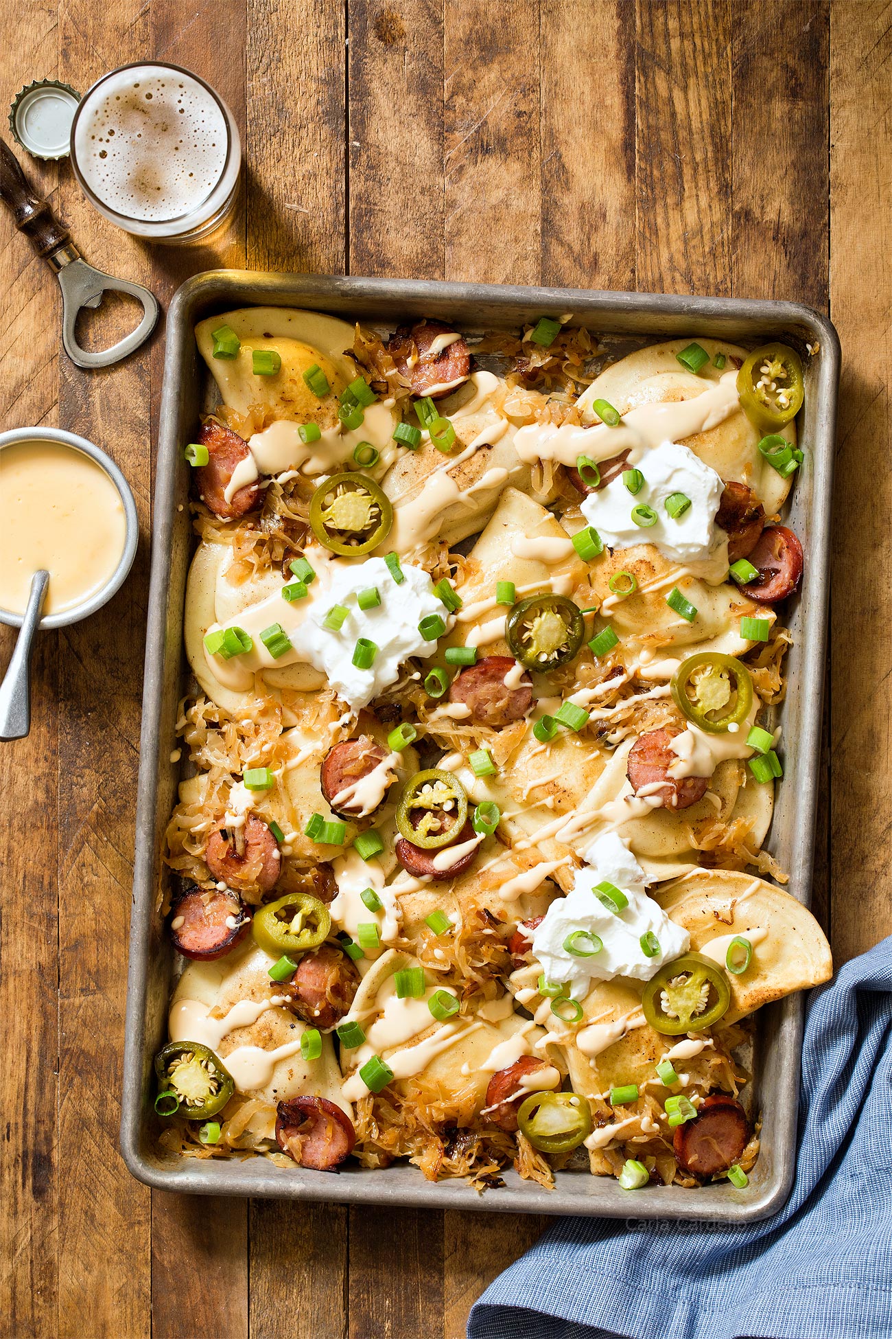 Recipe for Pittsburgh Pierogy Nachos with kielbasa, sauerkraut, and a homemade beer cheese sauce