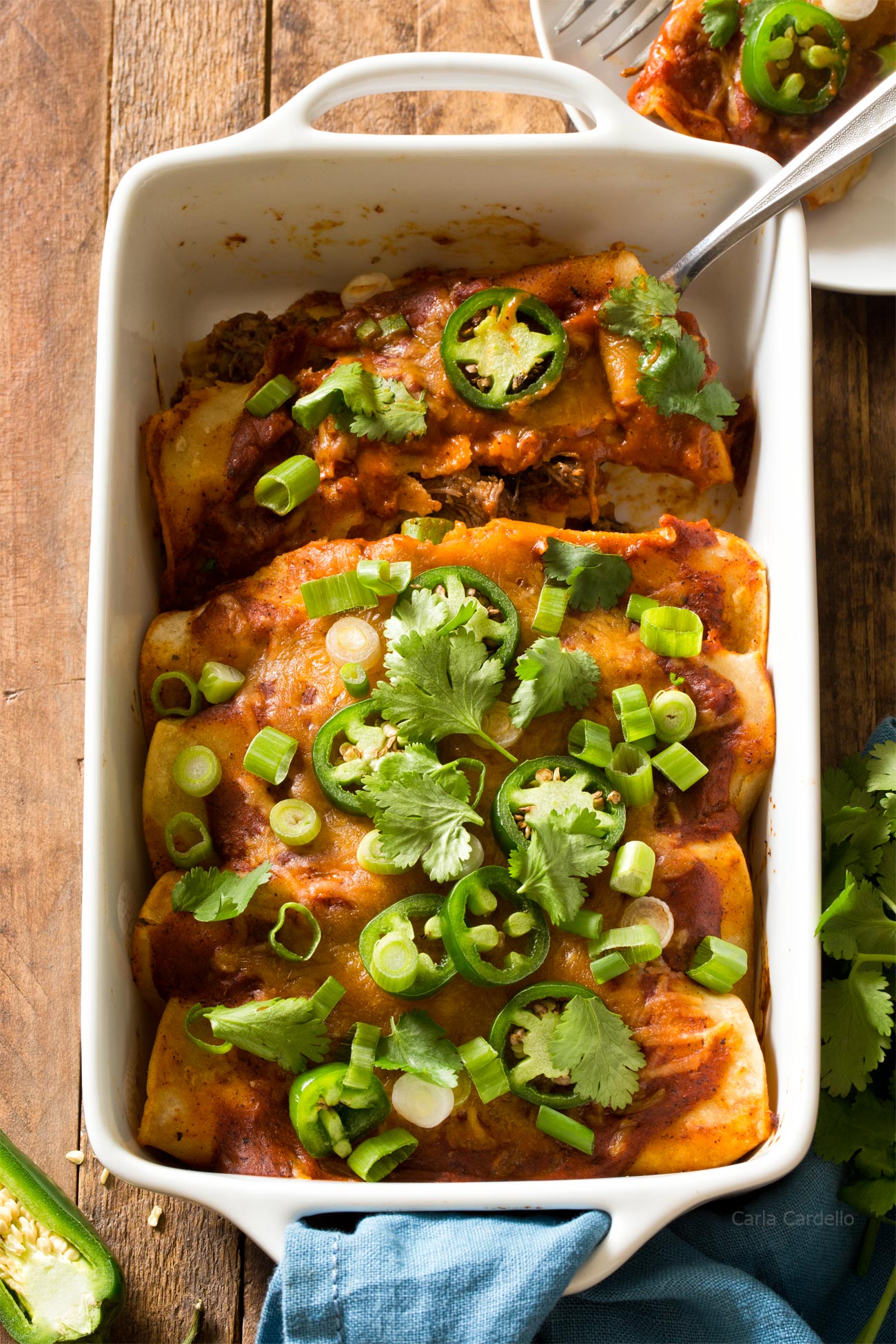 Beef Enchiladas in white casserole dish