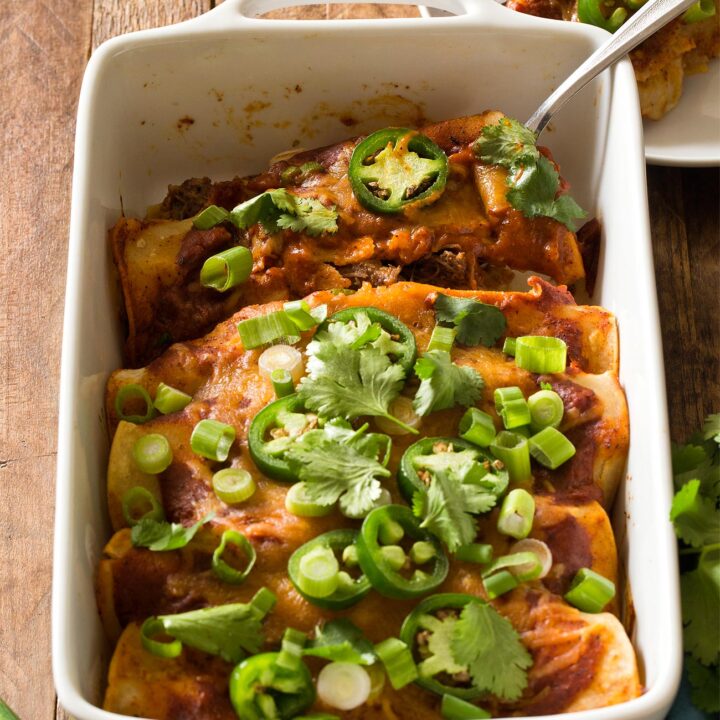 Beef Enchiladas in white casserole dish